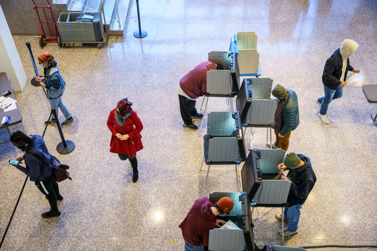 People vote at booths