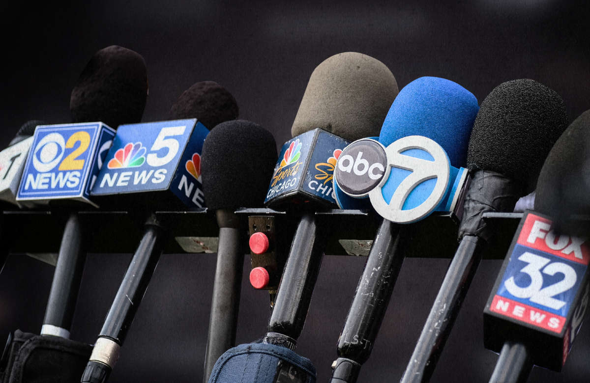 A detailed view of news channel microphones are seen lined up together to record a press conference