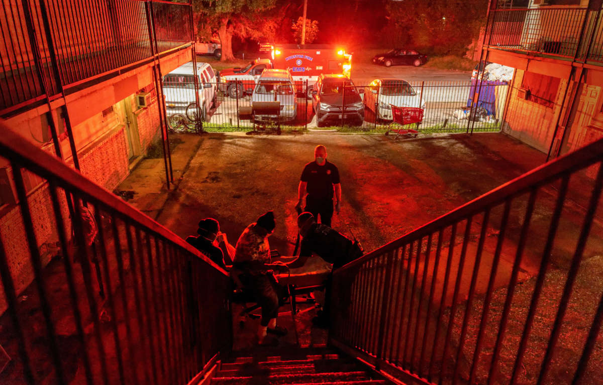 Houston Fire Department EMS medics transport a COVID-positive patient to a hospital on August 20, 2021, in Houston, Texas.