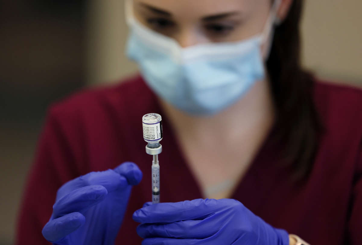 A registered nurse draws up a dose of the Pfizer COVID-19 booster at Park Avenue Health Center in Arlington, Massachusetts, on November 9, 2021.