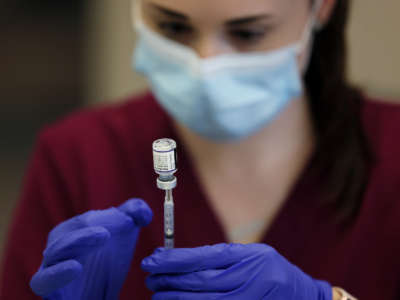 A registered nurse draws up a dose of the Pfizer COVID-19 booster at Park Avenue Health Center in Arlington, Massachusetts, on November 9, 2021.