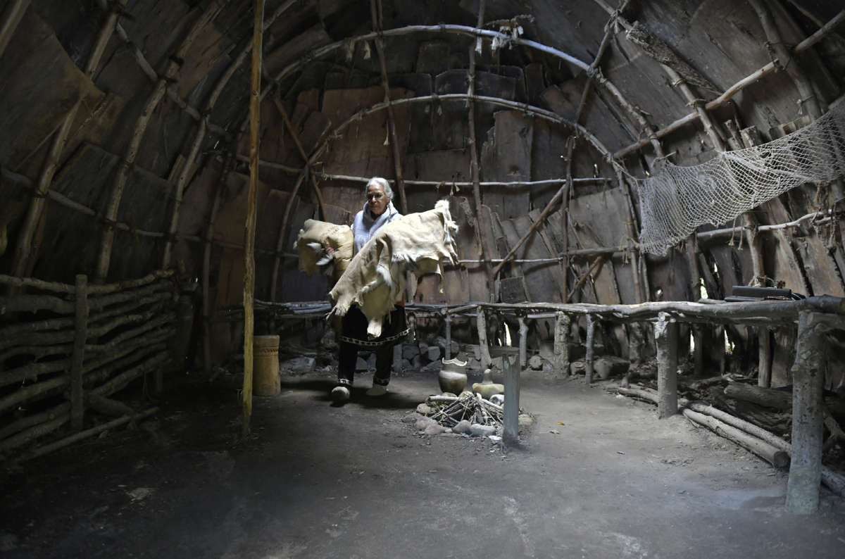 Anita Peters, who is Mashpee Wampanoag and goes by the name Mother Bear, packs up the traditional clothing and furnishings from the wetu, a traditional bark-covered wood-framed building that is part of the Mashpee Wampanoag Indian Museum 30 miles from Plymouth, Mass.