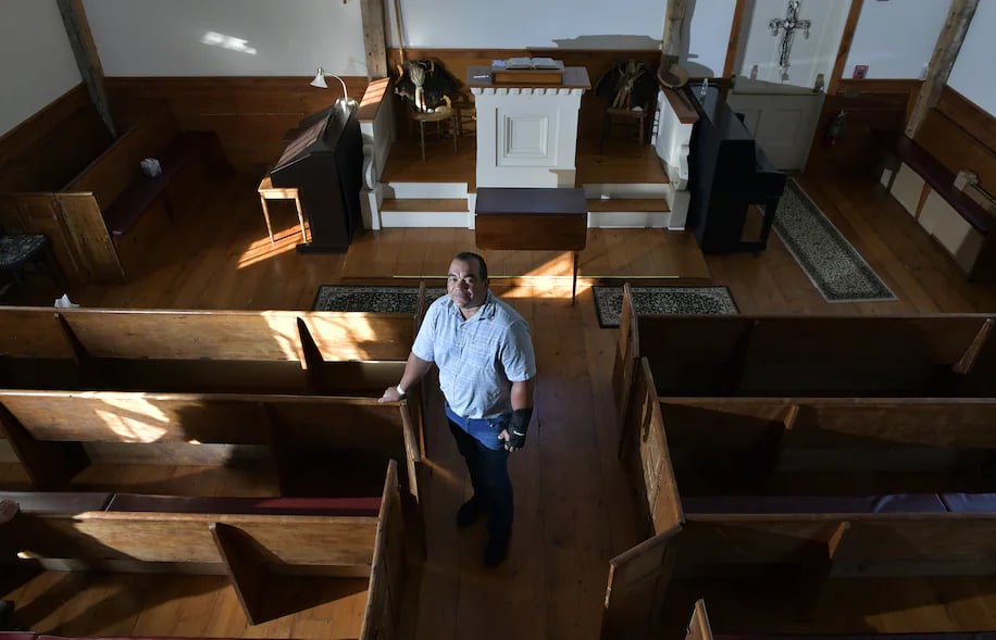 Darius Coombs, a Mashpee Wampanoag who serves as the tribe's cultural and outreach coordinator, stands in the old Indian Meeting House, built in 1684. It is one of the oldest American Indian churches in the eastern U.S.