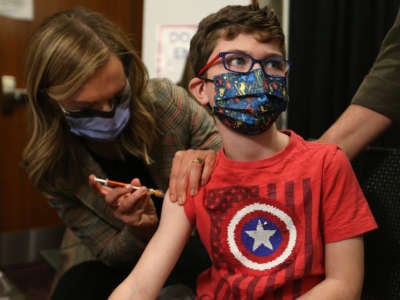 Children between the ages of 5 and 11 years old, who are part of the Hospital for Sick Children, are some of the first of that age group to get vaccinated for COVID-19 at the Metro Toronto Convention Centre in Toronto, Canada, on November 23, 2021.