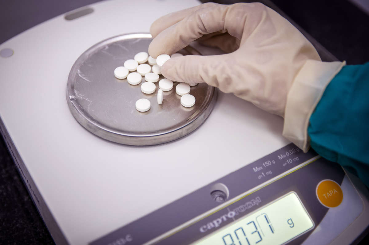 A person holds a freshly manufactured pill