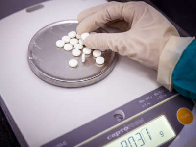 A person holds a freshly manufactured pill