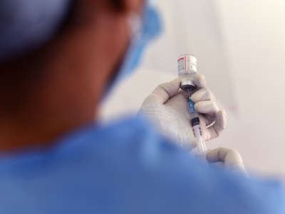 A medical worker fills a syringe with the covid-19 vaccine