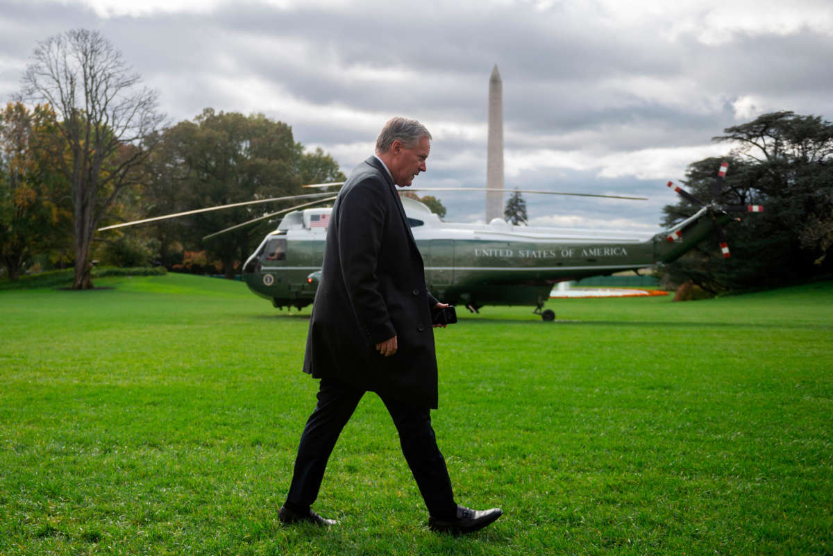 Mark Meadows walks past Marine One helicopter and Washington Monument in Washington, D.C.