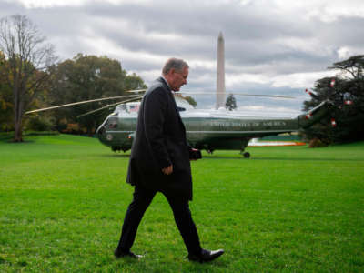 Mark Meadows walks past Marine One helicopter and Washington Monument in Washington, D.C.