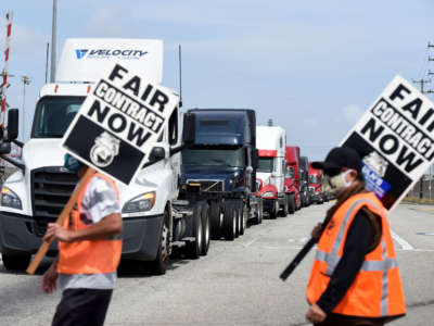 Longshore workers walk off the job in solidarity with teamsters to picket and disrupt traffic to one of the Port of Los Angeles's seven terminals in San Pedro on April 14, 2021.