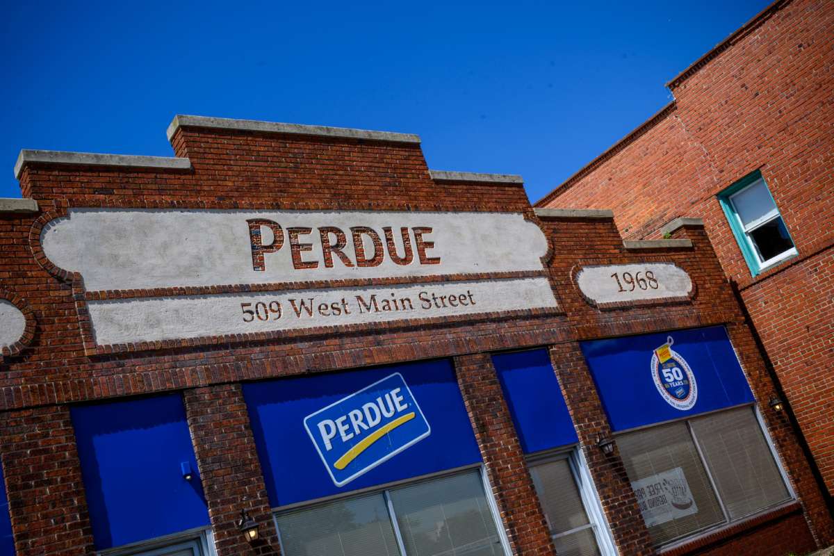 Perdue's company logo is seen on a building on the parking lot outside the Perdue Farms Chicken and poultry processing factory on May 2, 2020, in Salisbury, Maryland.