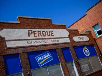 Perdue's company logo is seen on a building on the parking lot outside the Perdue Farms Chicken and poultry processing factory on May 2, 2020, in Salisbury, Maryland.