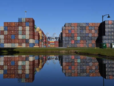 Shipping containers are seen reflected in a pond at the Port of Savannah in Georgia on October 23, 2021. The supply chain crisis has created a backlog of nearly 80,000 shipping containers at this port, the third-largest container port in the United States.