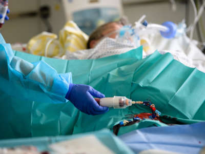 A doctor tends to a patient in the Covid-19 intensive care unit at University Hospital Leipzig on November 18, 2021 in Leipzig, Germany.