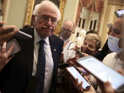 Sen. Bernie Sanders speaks with reporters after leaving a Senate Democrat luncheon on October 19, 2021, in Washington, D.C.