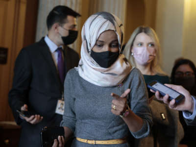 Rep. Ilhan Omar speaks with a reporter as she leaves the U.S. Capitol Building on November 16, 2021, in Washington, D.C.