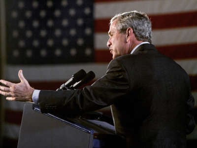 Former President George W. Bush gestures as he speaks on Homeland Security and the Patriot Act at the Port of Baltimore, in Maryland, on July 20, 2005.