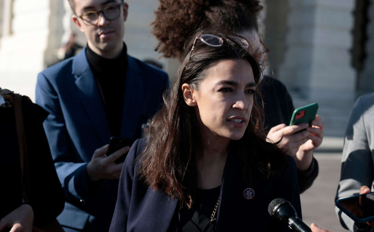 Rep. Alexandria Ocasio-Cortez speaks with reporters outside the U.S. Capitol Building on November 18, 2021, in Washington, D.C.