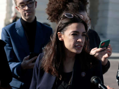 Rep. Alexandria Ocasio-Cortez speaks with reporters outside the U.S. Capitol Building on November 18, 2021, in Washington, D.C.
