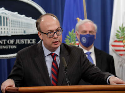 Acting Assistant Attorney General Jeffrey Clark speaks next to Deputy Attorney General Jeffrey Rosen at a news conference at the Justice Department in Washington, D.C., on October 21, 2020.