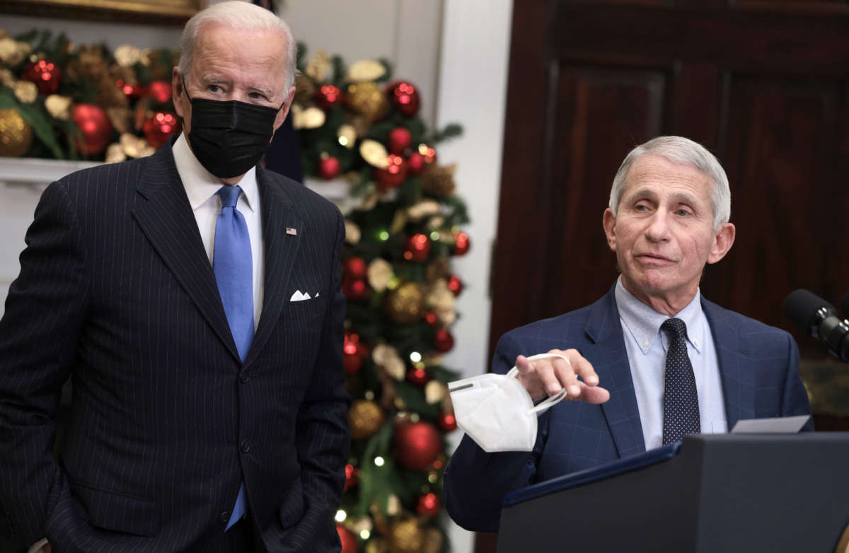 Anthony Fauci, right, Director of the National Institute of Allergy and Infectious Diseases and Chief Medical Advisor to the President, speaks alongside President Joe Biden as he delivers remarks on the Omicron COVID-19 variant at the White House on November 29, 2021, in Washington, D.C.