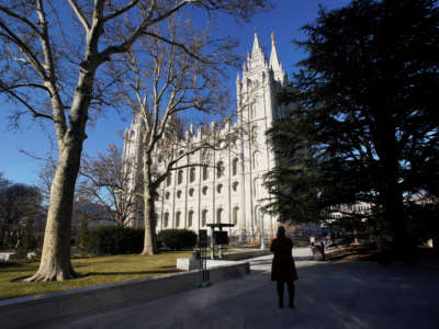 A woman takes a picture of The Church of Jesus Christ of Latter-Day Saints on December 17, 2019, in Salt Lake City, Utah.