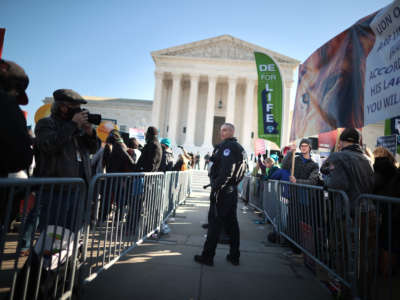 Police use metal barricades to keep protesters, demonstrators and activists apart in front of the U.S. Supreme Court on December 1, 2021, in Washington, D.C.