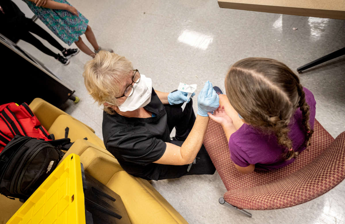 A student is administered a test by a Wild Health nurse during a COVID-19 testing day at Brandeis Elementary School on August 17, 2021, in Louisville, Kentucky.