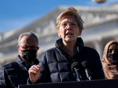 Flanked by Senate Majority Leader Chuck Schumer and Rep. Ilhan Omar, Sen. Elizabeth Warren speaks during a press conference about student debt outside the U.S. Capitol on February 4, 2021, in Washington, D.C.