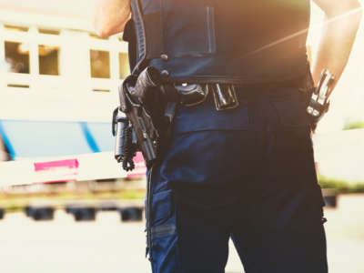 View from behind police officer with gun belt