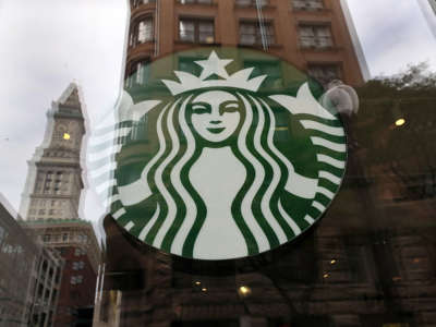 A temporarily closed Starbucks on State Street in Boston and the reflection of Custom House Tower in its window on August 9, 2021.