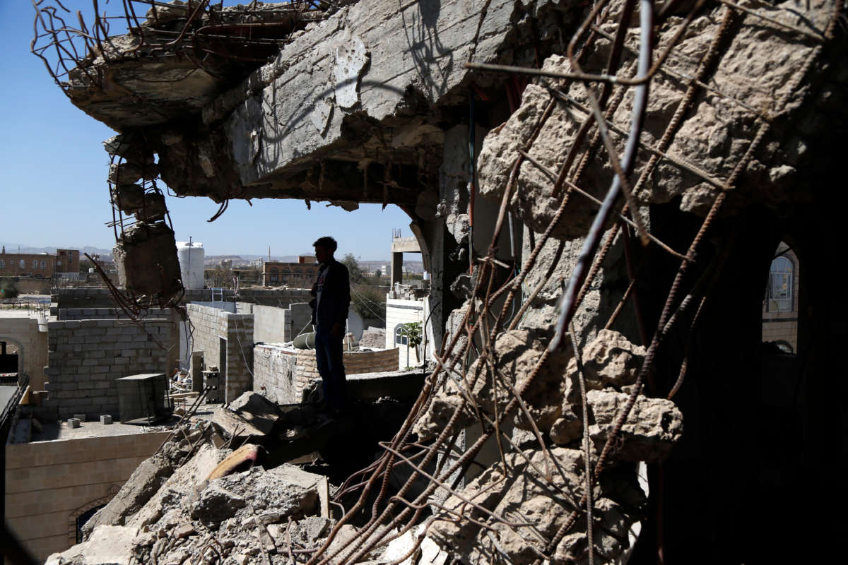 A Yemeni man inspects a house that was destroyed in an air strike carried out by the Saudi-led coalition, on February 5, 2021, in Sana'a, Yemen.