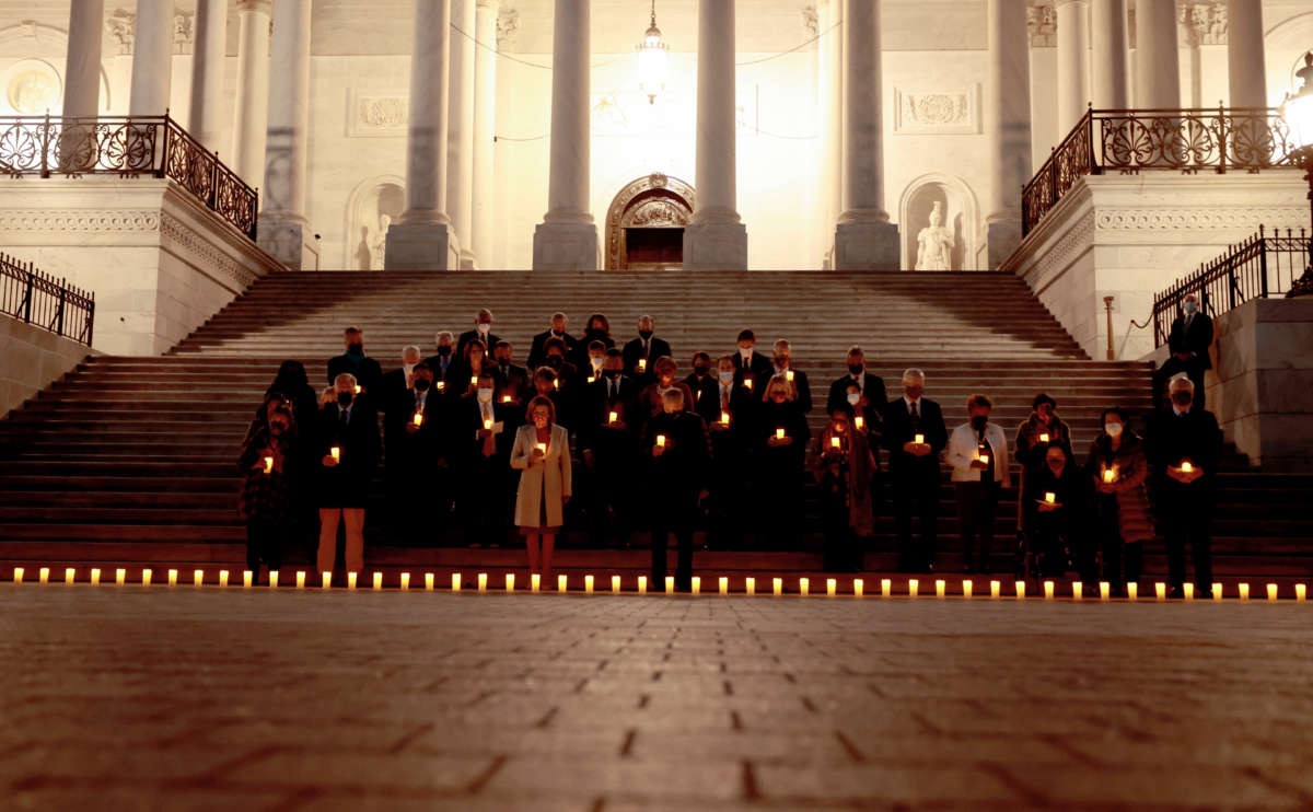 Lawmakers participate in a moment of silence for the 800,000 American lives lost to COVID-19 on December 14, 2021, in Washington, D.C.