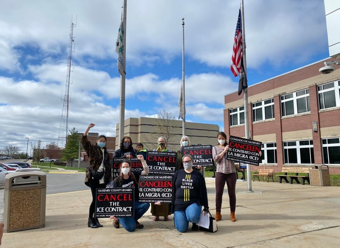 Members of the Coalition to Cancel the ICE Contract in McHenry County stand outside the McHenry County Jail in Woodstock, Illinois.