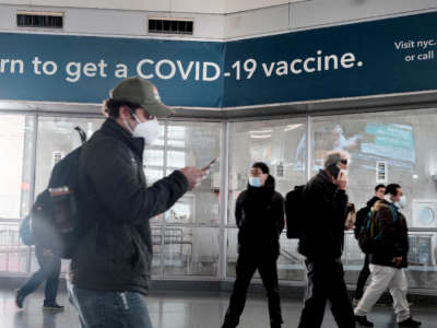 A sign urges people to get the COVID vaccine at the Staten Island Ferry terminal on November 29, 2021, in New York City.