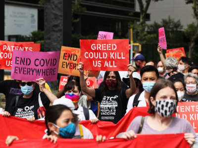 People gather for a protest demanding Pfizer and wealthy nations make the COVID-19 vaccine and treatments more accessible at One Dag Hammarskjöld Plaza on July 14, 2021, in New York City.