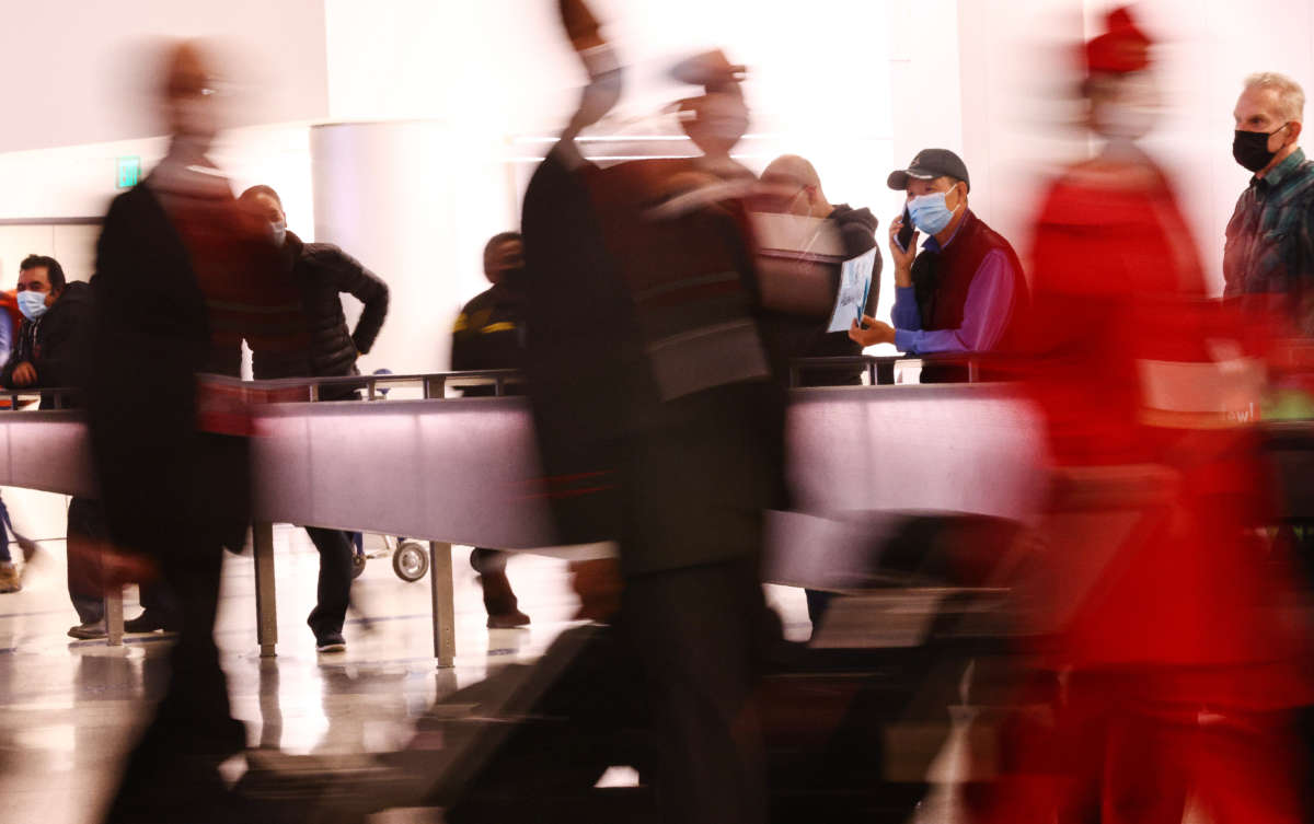 Flight crew members arrive on the first day of a new rapid COVID-19 testing site for arriving international passengers at Los Angeles International Airport on December 3, 2021, in Los Angeles, California.