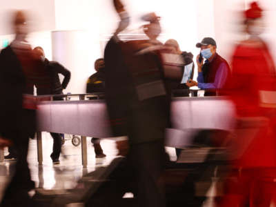 Flight crew members arrive on the first day of a new rapid COVID-19 testing site for arriving international passengers at Los Angeles International Airport on December 3, 2021, in Los Angeles, California.