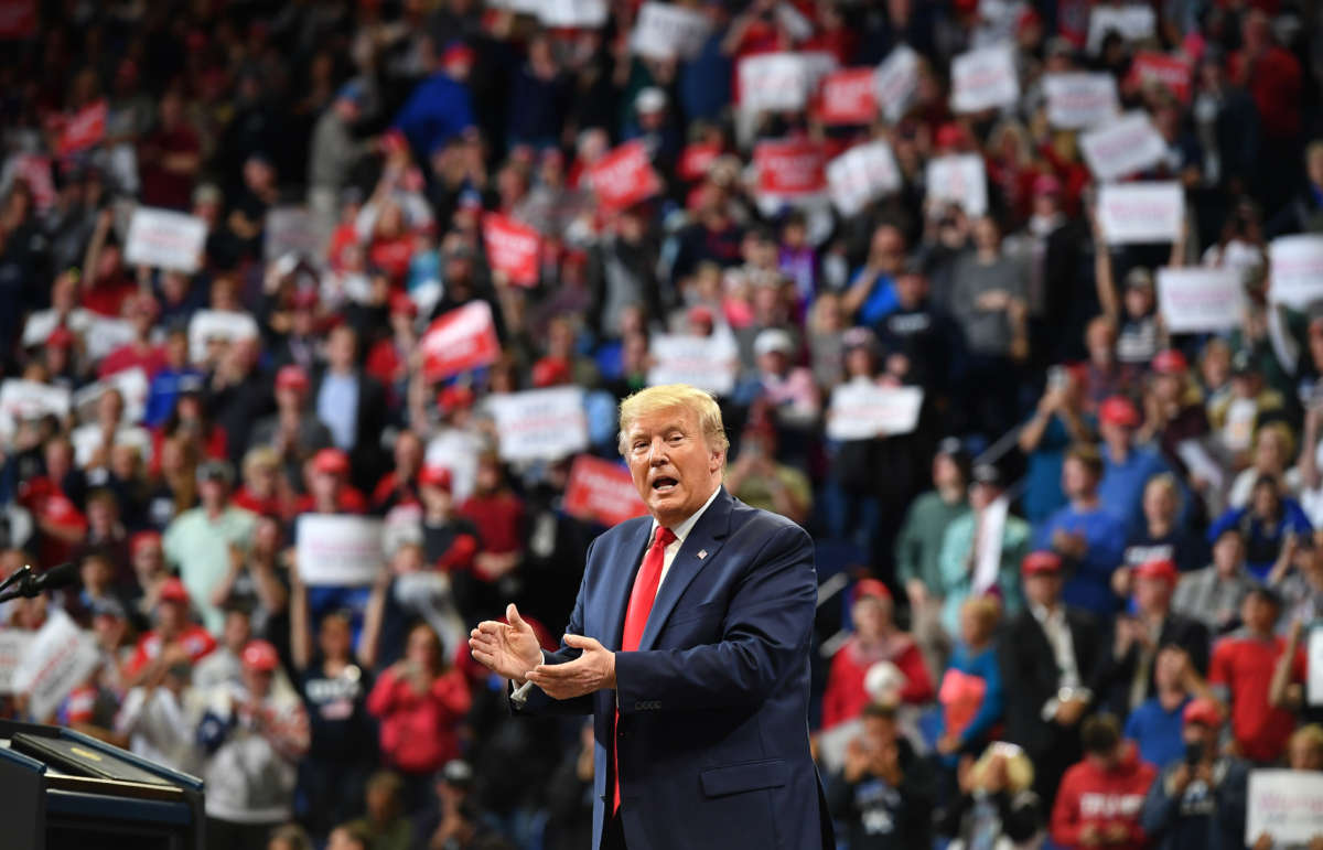 President Donald Trump claps during a rally at Rupp Arena in Lexington, Kentucky, on November 4, 2019.