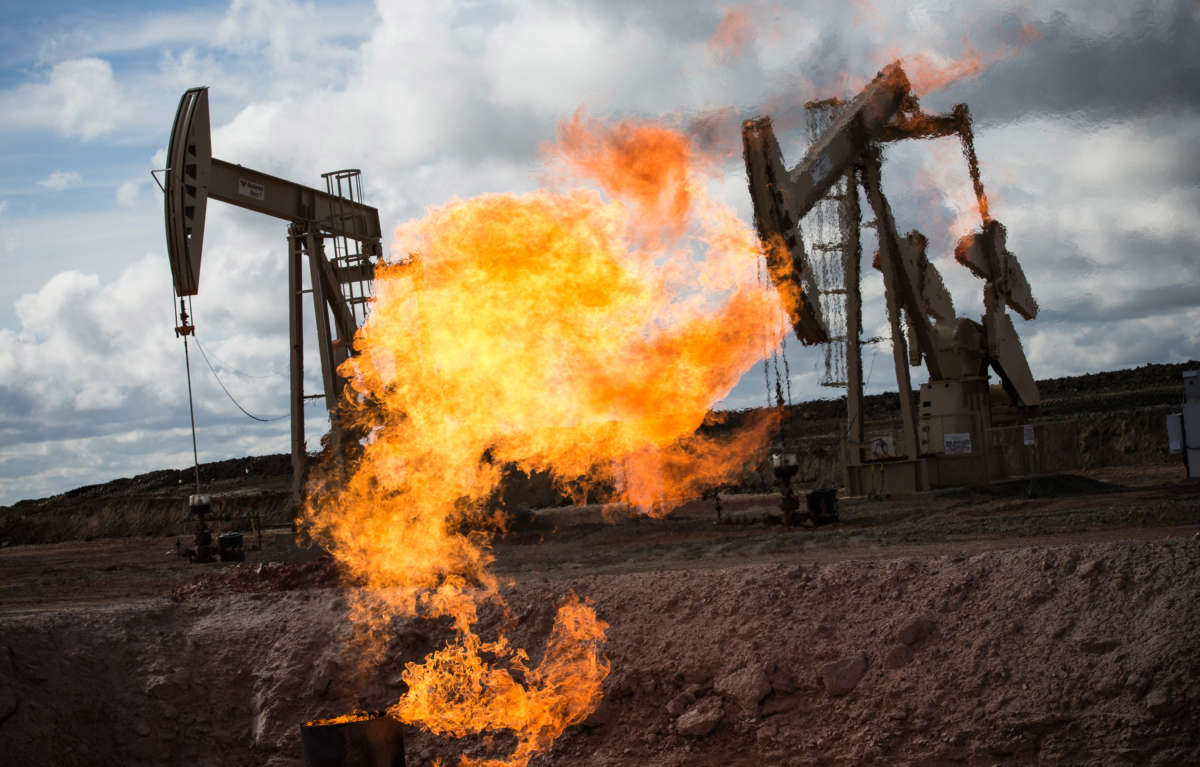 A gas flare is seen at an oil well site on July 26, 2013, outside Williston, North Dakota.