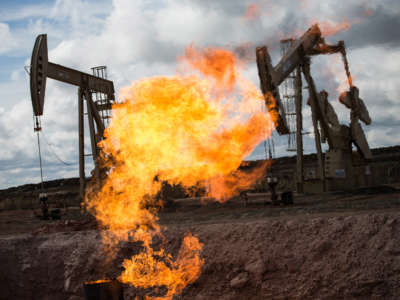 A gas flare is seen at an oil well site on July 26, 2013, outside Williston, North Dakota.