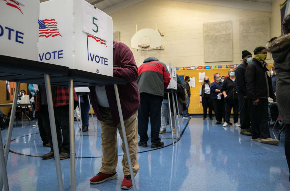 Voters fill out their ballots at a school gymnasium on November 3, 2020 in Lansing, Michigan.