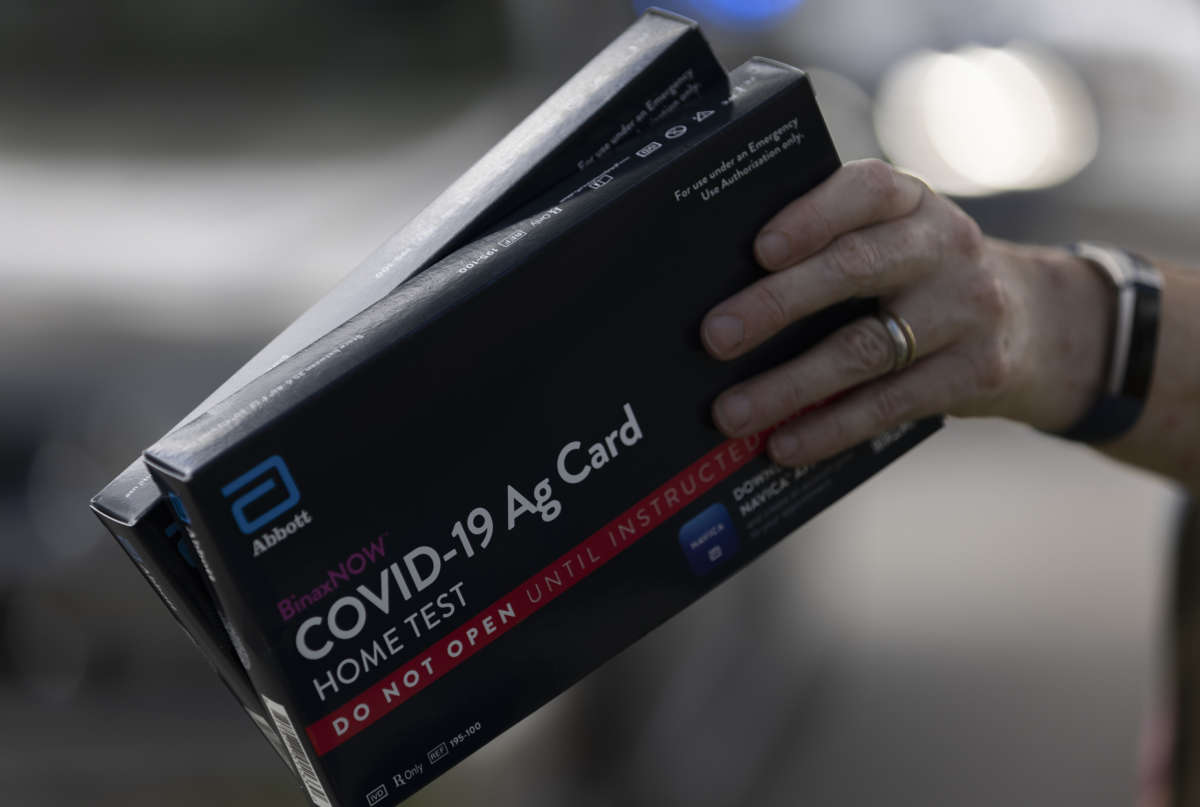 COVID-19 at-home rapid test kits are given away during a drive-thru event at the Hollywood Library on December 30, 2021, in Hollywood, Florida.