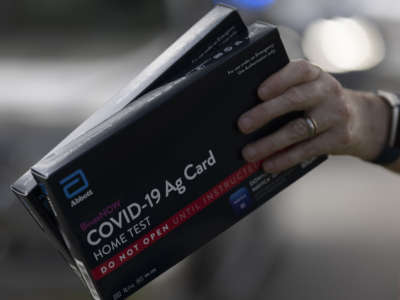 COVID-19 at-home rapid test kits are given away during a drive-thru event at the Hollywood Library on December 30, 2021, in Hollywood, Florida.