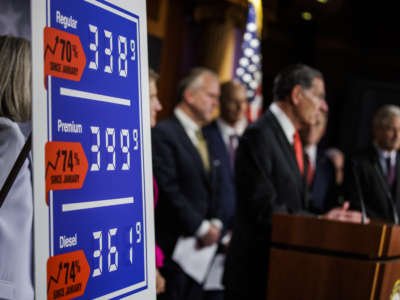 A poster showing gas price increases is seen as Sen. John Barrasso speaks alongside other Republican Senators during a press conference on rising gas an energy prices at the U.S. Capitol on October 27, 2021, in Washington, D.C.