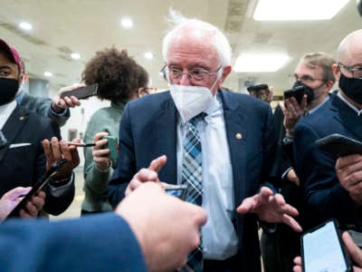 Sen. Bernie Sanders speaks with reporters in the Senate subway on December 13, 2021.