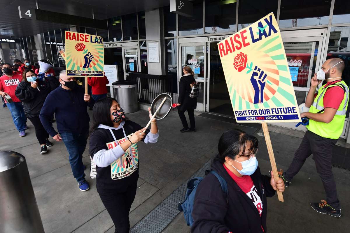 Los Angeles International Airport food workers demonstrate as they strike against airport concessions company HMSHost in Los Angeles, California, on December 22, 2021.