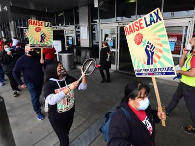 Los Angeles International Airport food workers demonstrate as they strike against airport concessions company HMSHost in Los Angeles, California, on December 22, 2021.