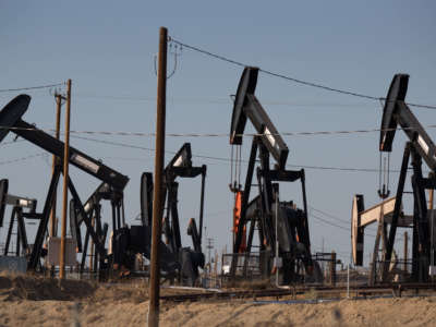 Oil pumpjacks line the horizon in Chevron's Kern River Oil Field, one of the largest in the United States, located just north and east of Bakersfield, on July 7, 2021, in Oildale, California.