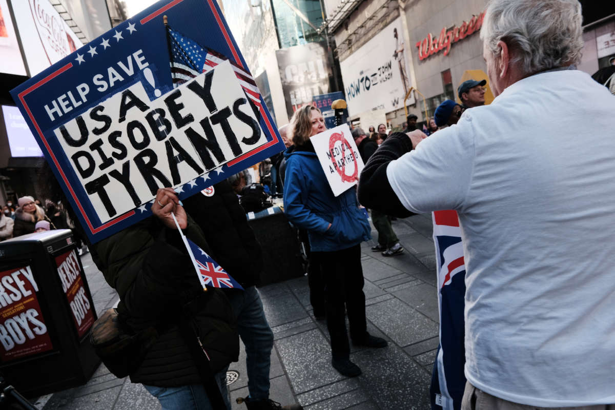 A group of protesters gather in Times Square in Manhattan to show their opposition to COVID-19 vaccines on December 5, 2021, in New York City.